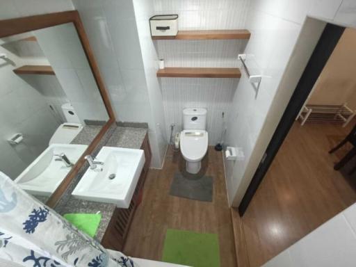 Modern bathroom interior with tiled walls and wooden details