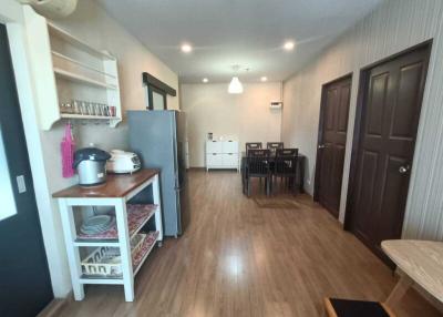 Modern kitchen with open dining area and wooden flooring