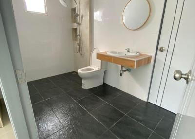 Modern bathroom with dark tile flooring