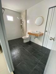 Modern bathroom with dark tile flooring