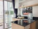 Modern kitchen with glass sliding door leading to balcony