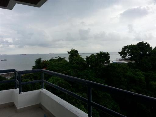 Spacious balcony with ocean view and greenery