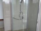 Modern glass-enclosed shower with tiled walls in bathroom