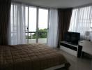 Bedroom with large window and ocean view