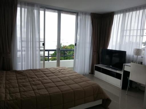 Bedroom with large window and ocean view