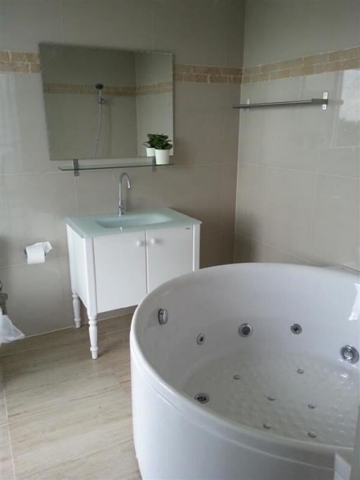 Modern bathroom interior with a corner whirlpool tub and walk-in shower