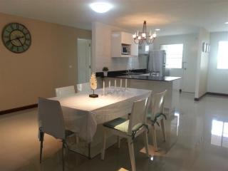 Modern kitchen with dining area and polished floor