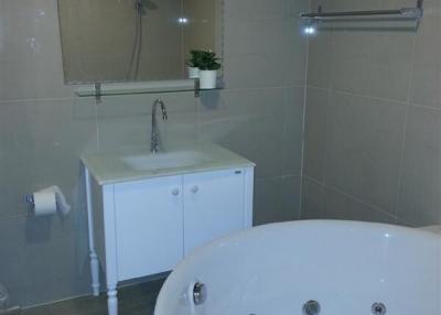 Modern bathroom with whirlpool tub and tiled walls