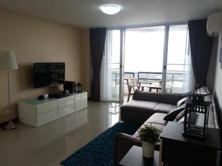 Spacious living room with modern amenities and balcony access