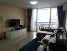 Spacious living room with modern amenities and balcony access