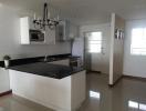 Modern kitchen with white cabinetry and stainless steel appliances