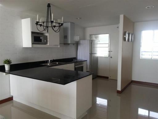 Modern kitchen with white cabinetry and stainless steel appliances