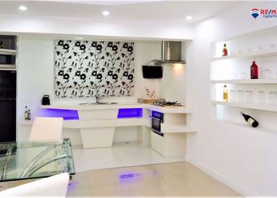 Modern kitchen with white cabinets and blue LED lighting
