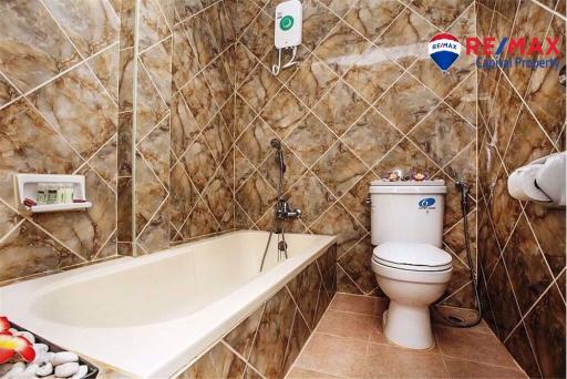 Modern bathroom with bathtub and tiled walls