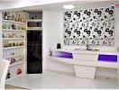 Modern kitchen with white cabinetry and black floral wallpaper