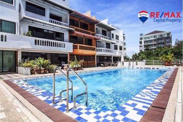 Swimming pool area with surrounding residential building
