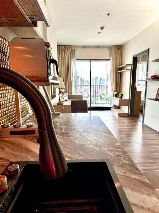 Modern kitchen with open layout overlooking living room and balcony