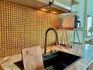 Modern kitchen with gold backsplash and marble countertops