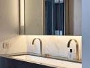 Modern bathroom interior with marble finish and gold fixtures