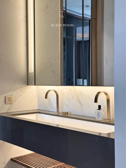 Modern bathroom interior with marble finish and gold fixtures