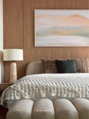 Elegant bedroom with a plush bed and artistic wall painting