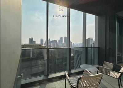 Modern balcony with urban skyline view and seating area