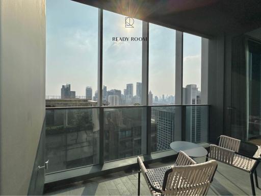 Modern balcony with urban skyline view and seating area