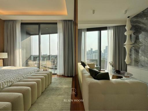 Modern bedroom with integrated living area and city view