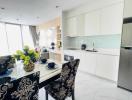 Modern kitchen with adjoining dining area featuring stylish decor and appliances