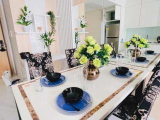 Modern kitchen with dining area, decorated with flowers and place settings