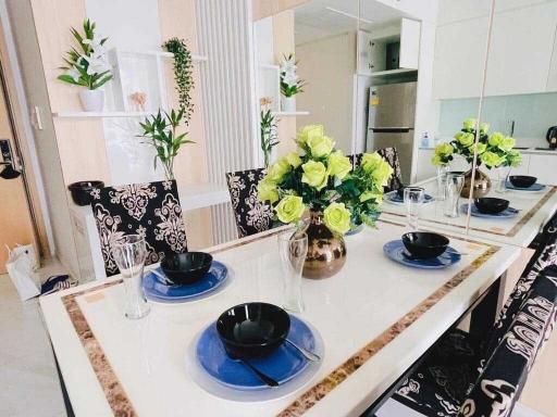 Modern kitchen with dining area, decorated with flowers and place settings