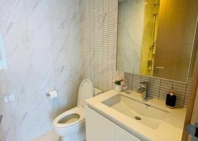 Modern bathroom with marble tiles and sleek fixtures