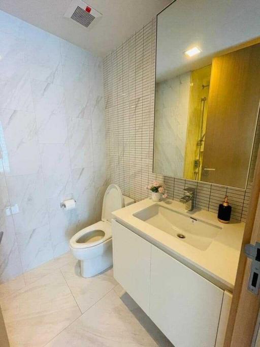 Modern bathroom with marble tiles and sleek fixtures