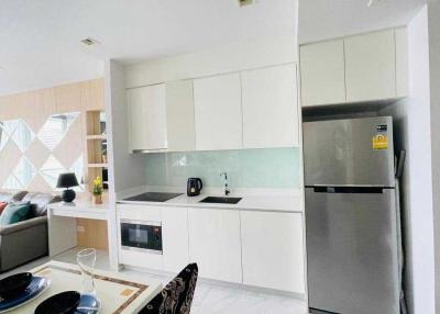 Modern white kitchen with built-in appliances and ample storage