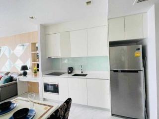 Modern white kitchen with built-in appliances and ample storage