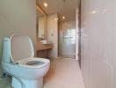 Modern bathroom with neutral color tiles and ample lighting