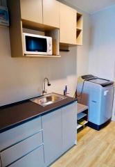 Compact kitchen with modern appliances and wooden flooring