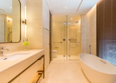 Modern bathroom with a freestanding tub, walk-in shower, and double vanity