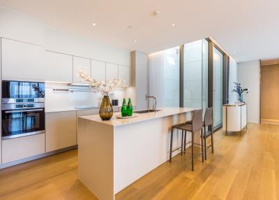 Modern kitchen with integrated appliances and breakfast bar