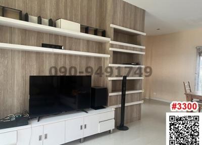 Spacious and modern living room with shelving units and entertainment system