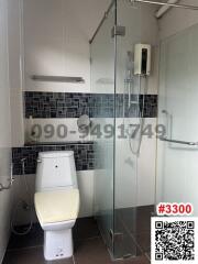 Modern bathroom with glass shower enclosure and wall-mounted toilet