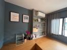 Cozy bedroom with grey walls, natural light, and shelving units