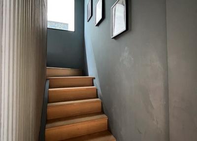 Modern staircase with wooden steps leading to the upper floor