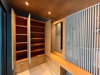 Spacious bedroom with built-in wooden wardrobe and modern design