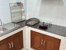 Compact kitchen with stainless steel sink and modern cooktop