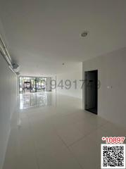 Spacious and bright unfurnished room with large windows and tiled flooring