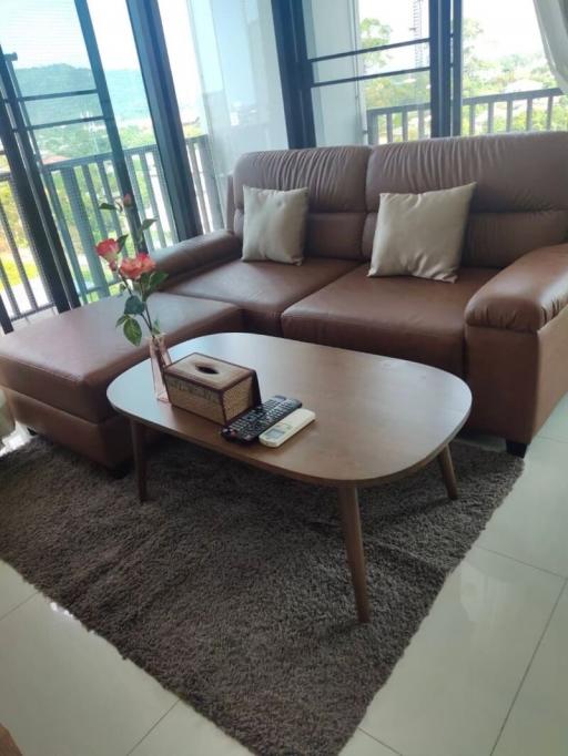 Cozy living room with a large sofa and a view of the outdoors