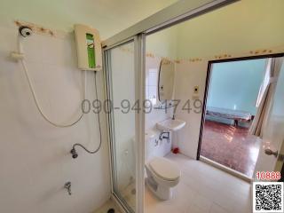 Bright bathroom with shower and access to balcony with sea view