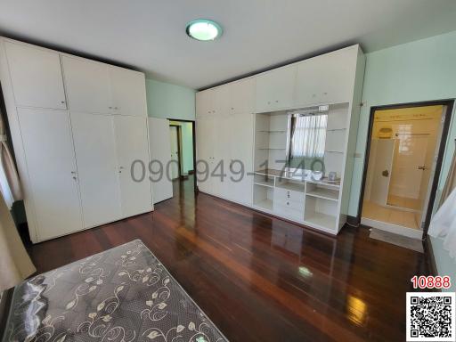 Spacious modern bedroom with large wardrobes and hardwood flooring