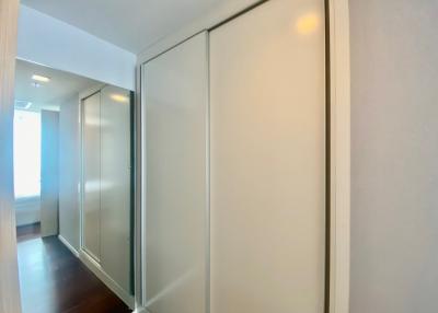 Bright hallway interior with sliding doors and hardwood flooring